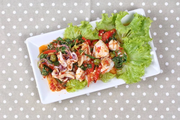 Thai food,Fried spicy mixed herb  with squid and lettuce. — Stock Photo, Image