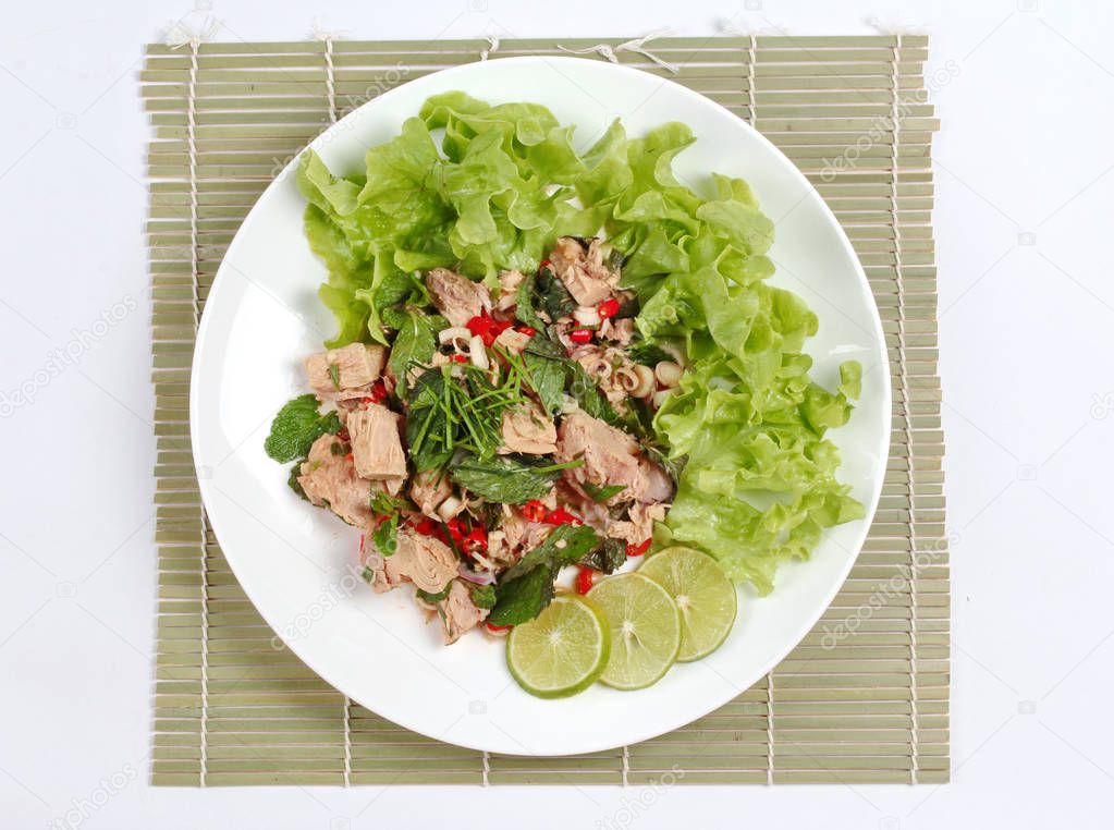 Spicy and sour mixed vegetable salad with canned tuna served .