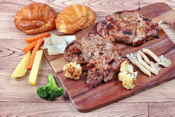 Home made ,Pork steak and mixed vegetables,croissants on butcher — Stock Photo, Image