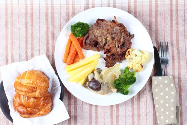 Home made ,Pork steak and mixed vegetables with croissants . — Stock Photo, Image