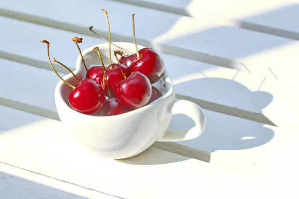 Cherries Chile in Heart-shaped mug on wood . — Stock Photo, Image