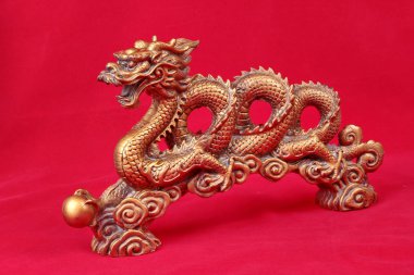 Golden dragon statue on red ,to celebrate for Chinese festival. clipart