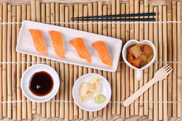 Salmon sushi and side dish served with Japanese yellow curry. — Stock Photo, Image