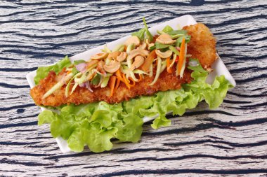 Baharatlı Dolly'nin balık salatası rulo yeşil mango ile kızartılmış.