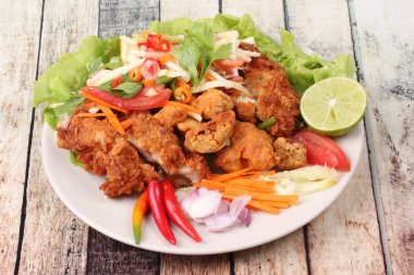 Rulo yeşil mango baharatlı kızarmış tavuk salatası .