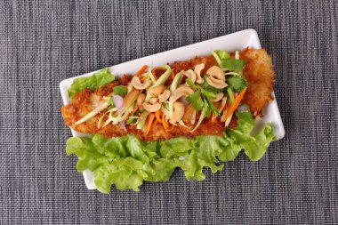 Baharatlı Dolly'nin balık salatası rulo yeşil mango ile kızartılmış.