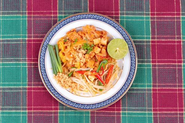 Popular Thai fried noodle call Pad Tai on Thai-pattern dish.