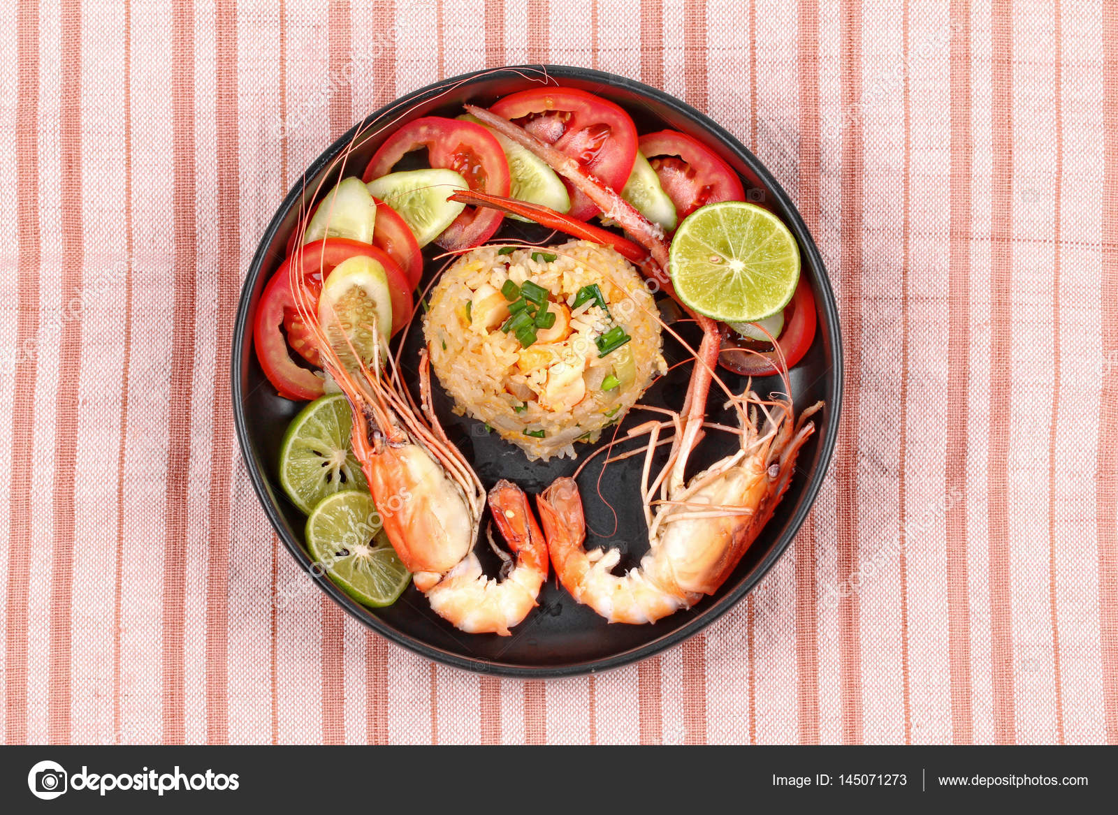 Fried Jasmine rice with large prawns in heart shape. Stock Photo by