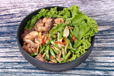 Baharatlı kızarmış börülce ve fesleğen ile dilimlenmiş yayın balığı.