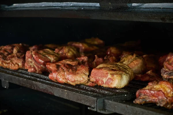Roasted meat in a large oven — Stock Photo, Image