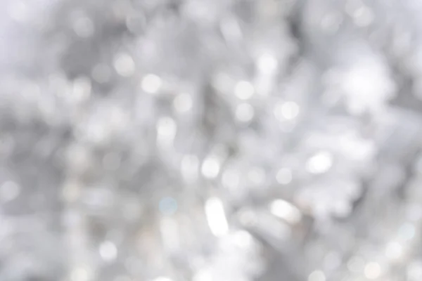 Festive silver Christmas background. Circles bokeh or particles.