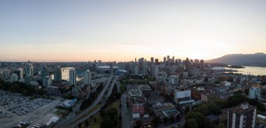 Aerial panoramic view of Downtown Vancouver, British Columbia, Canada, during a bright summer sunset. clipart