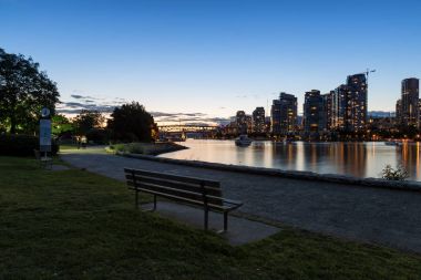 Gün batımı sırasında arka planda at False Creek ile Vancouver, Bc, Kanada, şehir merkezindeki bir parkta Bank.