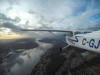 Cessna 172 Flying over City clipart