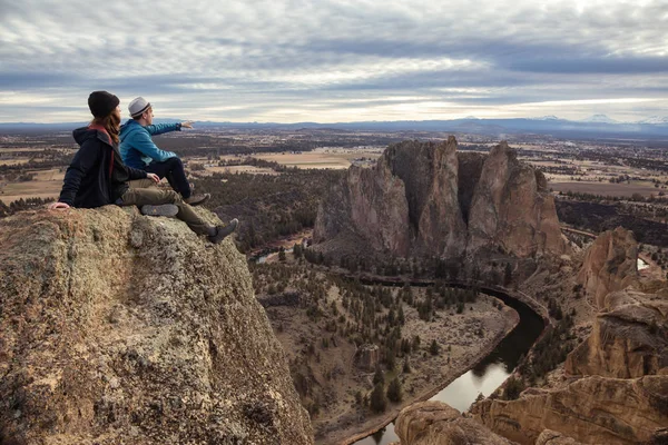 Friends enjoying the Beautiful American Mountain Landscape during a vibrant winter day. Taken in Smith Rock, Redmond, Oregon, America. Concept: Adventure, Holiday and Travel