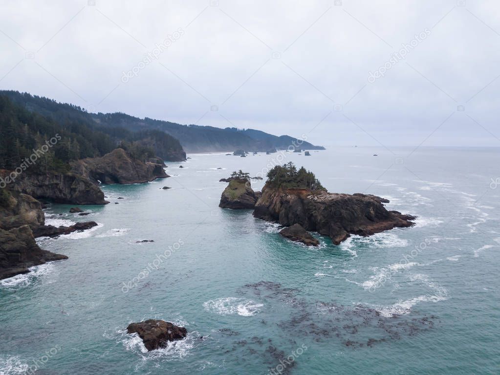 Aerial panoramic view of the Highway at Pacific Ocean Shore during a cloudy winter morning. Taken in Oregon Coast, North America.