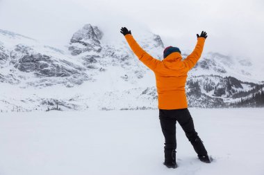 Renkli bir kıyafet macera adam Kollarını açarak güzel Kanada manzara keyif alıyor. Joffre Gölü, Vancouver, British Columbia, Kanada kuzeyindeki alınan.