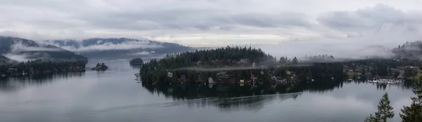 Beautiful panoramic view of Deep Cove from the Top of Quarry Rock. Taken in North Vancouver, British Columbia, Canada, during a vibrant winter morning.