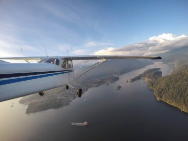 Küçük uçak üzerinde derin koyu canlı bir gün batımı sırasında uçan. Vancouver, British Columbia, Kanada alınan.