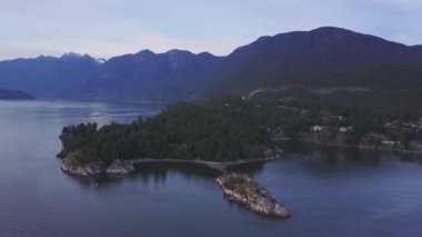 Havadan görünümü renkli bir gün batımı sırasında kayalık güzel kıyısında. Video alınan Whytecliff Park, Horseshoe Bay, Batı Vancouver, British Columbia, Kanada.