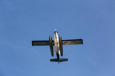 Vancouver, British Columbia, Canada - October 11, 2019: View from below of a Seaplane flying with blue sky background during a sunny day.