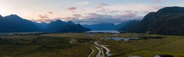 Beautiful Aerial Panoramic View of Canadian Mountain Landscape during a vibrant summer sunset. Taken near Pitt Lake, Near Vancouver, British Columbia, Canada.