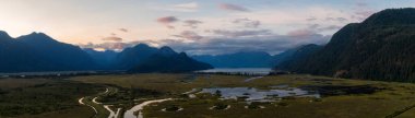 Beautiful Aerial Panoramic View of Canadian Mountain Landscape during a vibrant summer sunset. Taken near Pitt Lake, Near Vancouver, British Columbia, Canada.