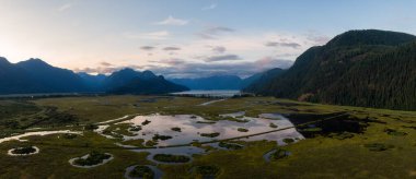 Beautiful Aerial Panoramic View of Canadian Mountain Landscape during a vibrant summer sunset. Taken near Pitt Lake, Near Vancouver, British Columbia, Canada.