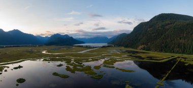 Beautiful Aerial Panoramic View of Canadian Mountain Landscape during a vibrant summer sunset. Taken near Pitt Lake, Near Vancouver, British Columbia, Canada.