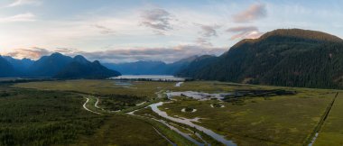 Beautiful Aerial Panoramic View of Canadian Mountain Landscape during a vibrant summer sunset. Taken near Pitt Lake, Near Vancouver, British Columbia, Canada.