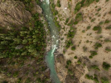 Aerial View from Above of a beautiful Green River running in the valley during a summer day. Taken near Lillooet, British Columbia, Canada.