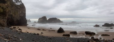 Ecola State Park, Cannon Beach, Oregon, United States. Beautiful Panoramic View of the Sandy and Rocky Beach on Pacific Ocean Coast during a cloudy summer sunrise. clipart