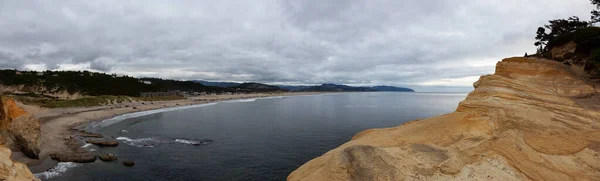 Pacific City, Oregon Coast, United States of America. Beautiful Panoramic View of a small touristic town on the Ocean Coast during a cloudy summer evening.