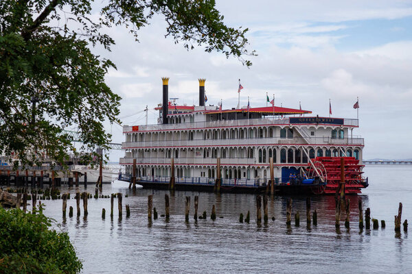 Astoria, Oregon, United States - September 9, 2019: Sternwheeler parked at the marina on Columbia River during a cloudy summer morning.