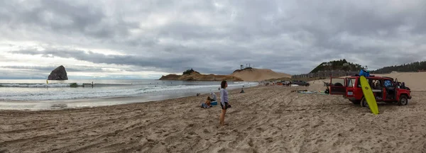 Pacific City, Oregon Coast, United States of America - September 7, 2019: Panoramic View of a beautiful sandy beach on the Ocean Coast during a cloudy summer evening.