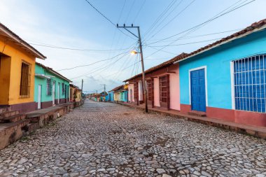 Bulutlu ve güneşli bir gündoğumu sırasında küçük bir Küba kasabasındaki yerleşim yerinin sokak manzarası. Trinidad, Küba 'da çekildi.