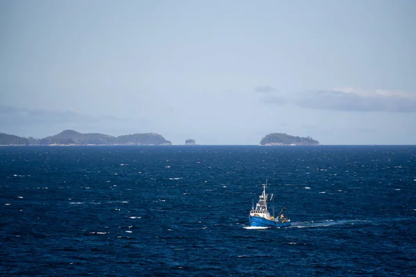 stock image Northern Vancouver Island, British Columbia, Canada - September 27, 2019: Fishing Boat in the Pacific Ocean during a sunny and cloudy day with Islands and the Mainland in the background.