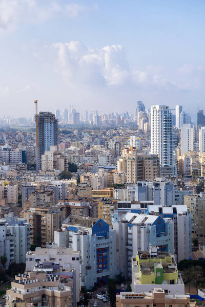 Netanya, Center District, Israel - April 4, 2019: Aerial view of a residential neighborhood in a city during a cloudy and sunny sunrise.