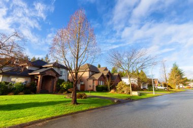 Residential Suburban Neighborhood in the City during a vibrant winter sunrise. Taken in Fraser Heights, Surrey, Vancouver, BC, Canada. Wide Angle clipart