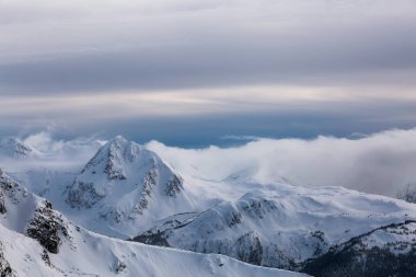 Whistler, British Columbia, Kanada. Kanada Karlı Dağ manzarasının güzel panoramik manzarası bulutlu ve canlı kış günbatımında.