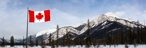 Blaeberry River, near Golden, British Columbia, Canada. Beautiful panoramic Canadian Landscape View of Frozen water and mountains in winter. With Flag Composite