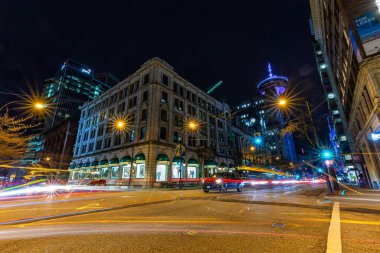 Downtown Vancouver, British Columbia, Canada - Feb 22, 2020: Night View of a Street Corner in the Modern Urban City after sunset.