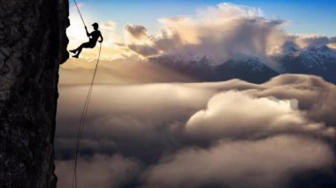 Cinemagraph Continuous Loop. Man Unrecognizable Rappelling from Cliff