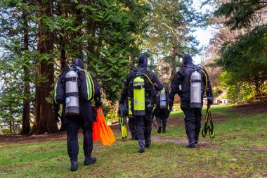 Horseshoe Bay, West Vancouver, British Columbia, Canada - Feb 29, 2020: Scuba Diver getting ready to go diving at Whytecliff Park during sunny winter day.