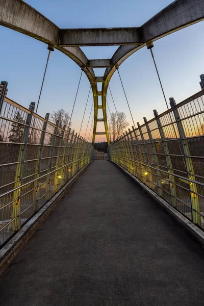 Pedestrian Bridge over the Highway during a sunny colorful sunset. Taken in Surrey, Vancouver, British Columbia, Canada.