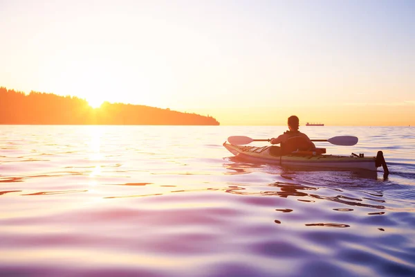 Woman on a sea kayak is paddling in the ocean — Stock Photo, Image
