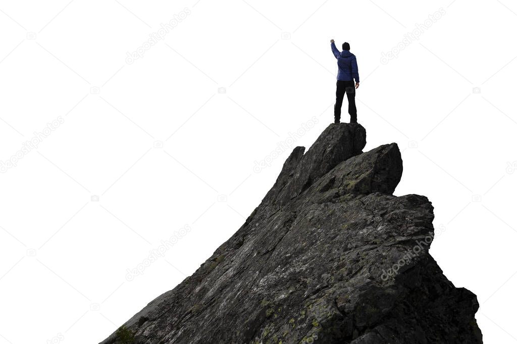 Adventurous Man Hiker With Hands Up on top of a Steep Rocky Cliff.