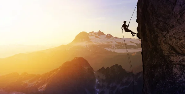 Silhouette Rappelling from Cliff — Stock Photo, Image