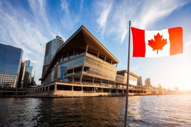 National Canadian Flag with Modern Downtown City in Background clipart