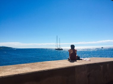 Monaco, Fransa - 08 Ağustos, 2016: yalnız bir kız bir c üzerinde oturuyor